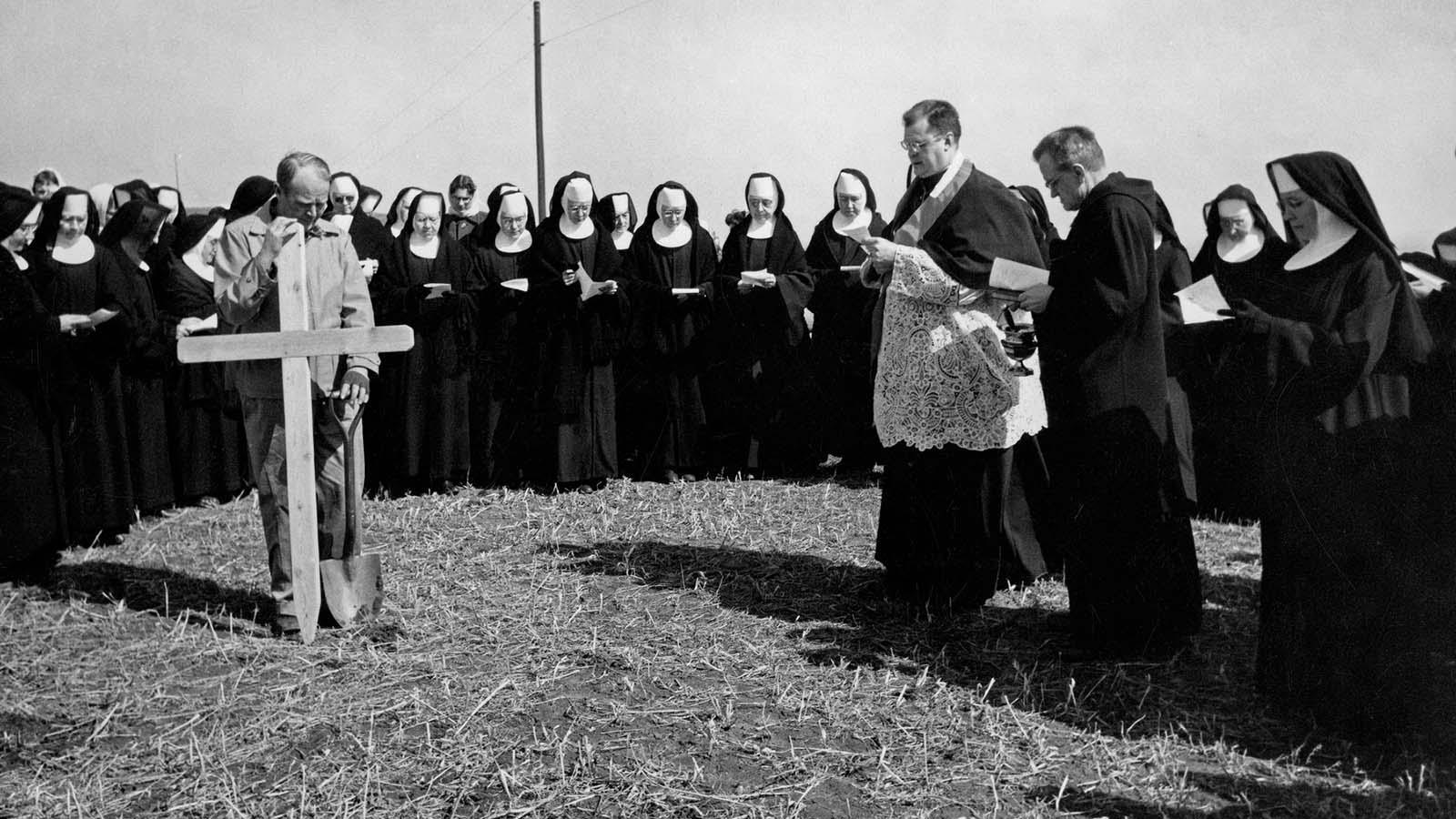 Photo of historic Mary community gathered together to install original wooden cross